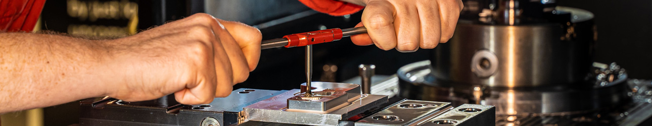 guy working on tooling piece for plastics manufacturing - optionpak